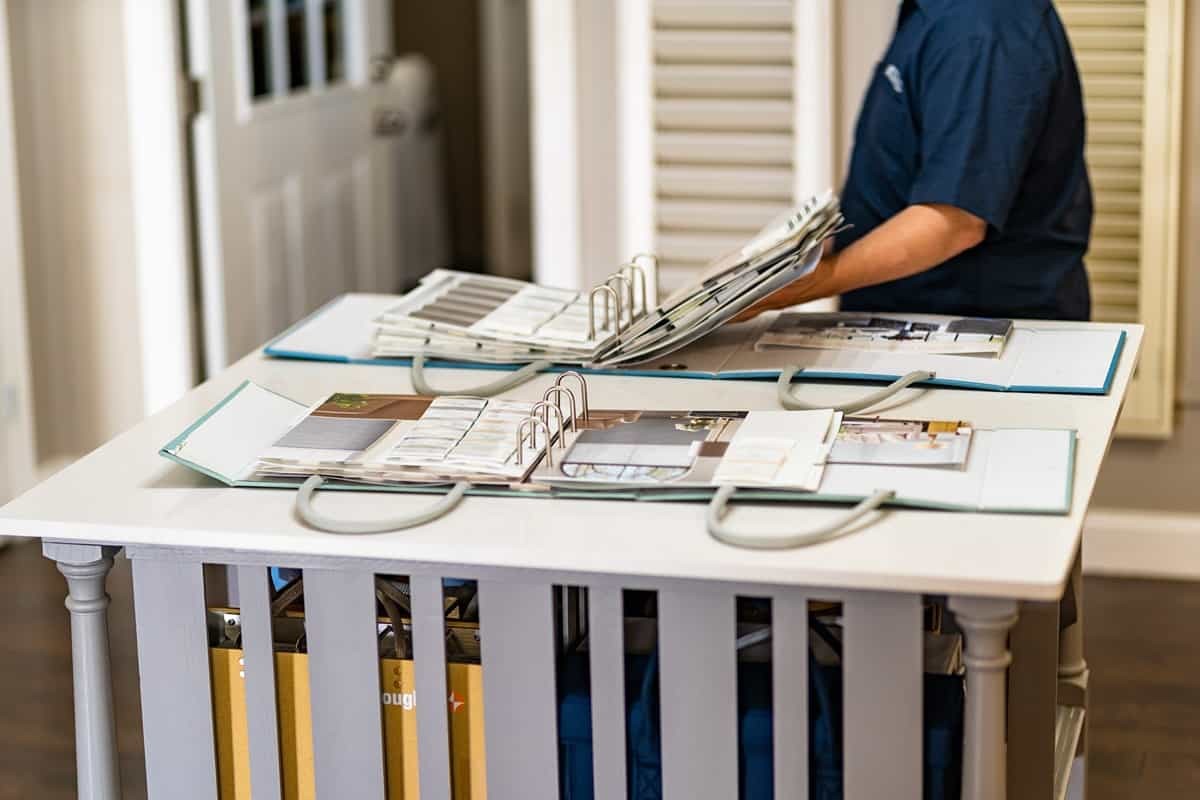 Blind and Shutter Gallery Team Member Looking at Sample Books near Nashville, Tennessee (TN)